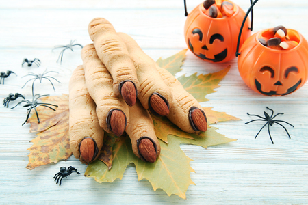 Halloween finger cookies with spiders on white wooden tableの写真素材
