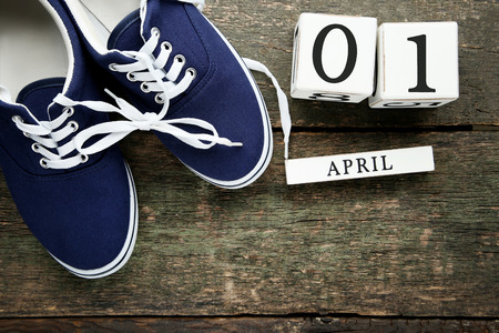 Calendar cubes with blue sport shoes on wooden table