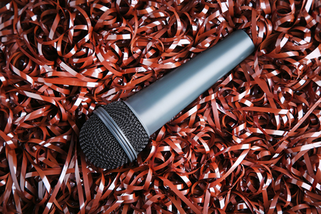 Black microphone on brown audio tapeの写真素材