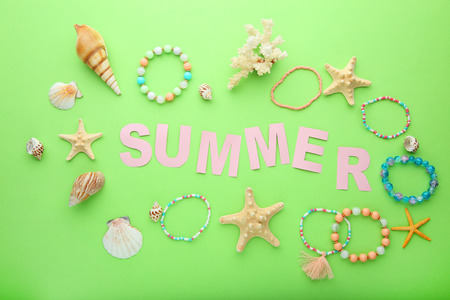 Inscription Summer with seashells on green backgroundの写真素材