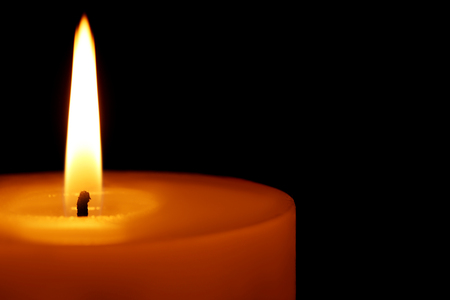 Burning candle on black backgroundの写真素材
