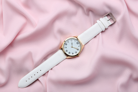 Wrist watch on pink satin backgroundの写真素材