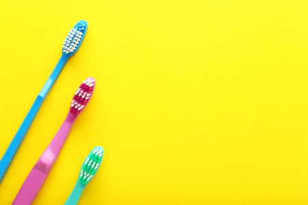 Toothbrushes on yellow backgroundの写真素材