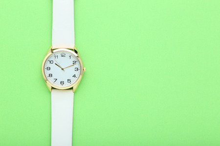 Wrist watch on green backgroundの写真素材