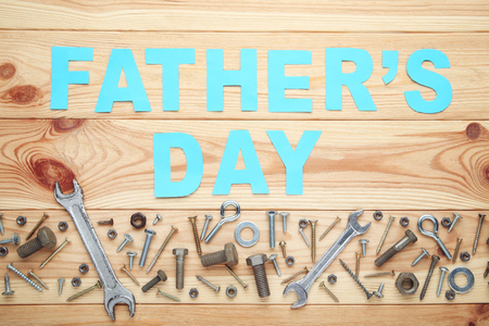 Inscription Fathers Day with tools on brown wooden tableの写真素材