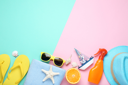 Summer accessories withdecorative ship and orange fruit on colorful backgroundの写真素材