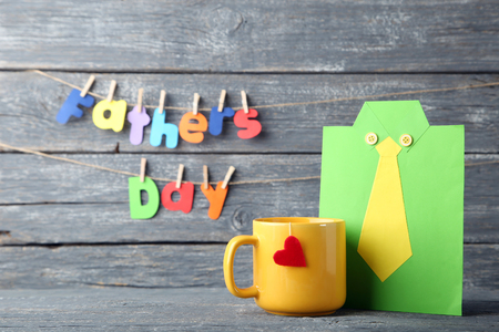 Yellow cup with paper shirt and inscription Fathers Dayの写真素材
