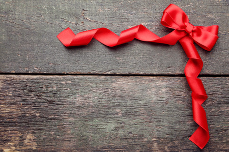 Red bow with ribbon on grey wooden tableの写真素材