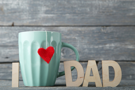 Inscription I Love Dad with cup on wooden backgroundの写真素材