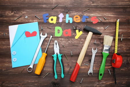 Inscription Fathers Day with different tools on wooden tableの写真素材
