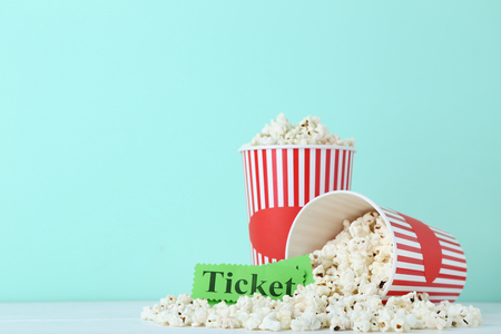Popcorn in striped buckets on mint backgroundの写真素材