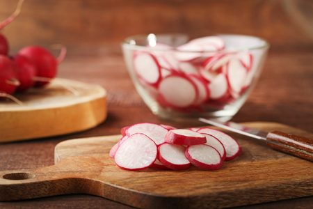 Sliced red radish on cutting boardの写真素材