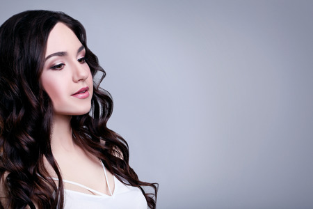 Portrait of beautiful woman on grey backgroundの写真素材