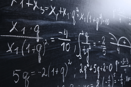 Maths formulas on chalkboard background