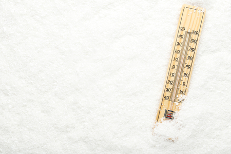 Wooden thermometer in white snowの写真素材