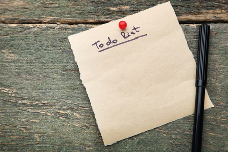 To do list on brown paper with felt-pen on wooden tableの写真素材