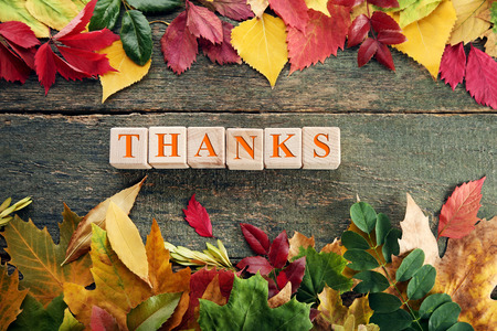 Autumn leafs with wooden cubes on grey tableの写真素材