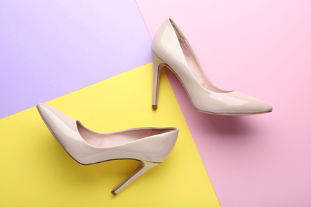 Beige high heel shoes on colorful backgroundの写真素材