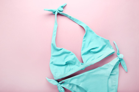 Blue swimsuit on pink backgroundの写真素材