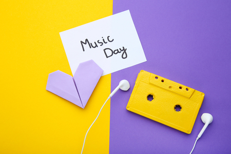 Cassette tape with earphones and paper heart on colorful backgroundの写真素材