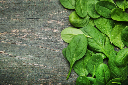 Spinach leafs on grey wooden tableの写真素材