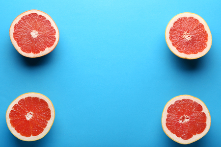 Ripe grapefruit slices on blue backgroundの写真素材