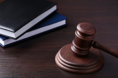 Judge gavel with books on wooden tableの写真素材