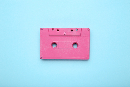Pink cassette tape on blue backgroundの写真素材