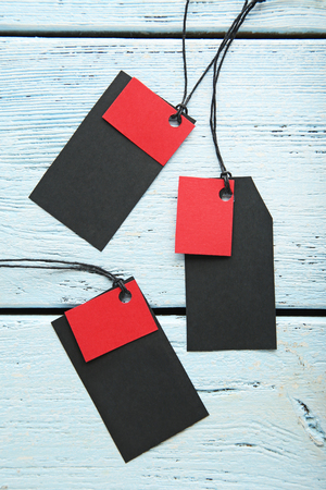 Black sale tags on wooden tableの写真素材