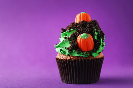 Halloween cupcake on purple backgroundの写真素材