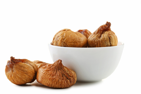 Dried figs in bowl isolated on white backgroundの写真素材