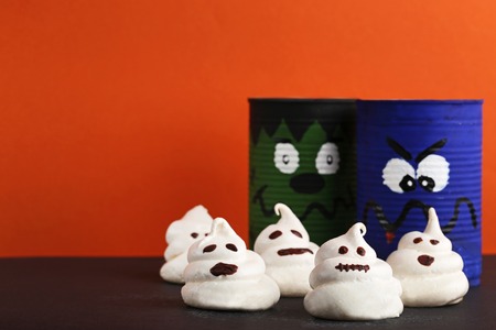 Halloween meringue with painted jars on orange backgroundの写真素材