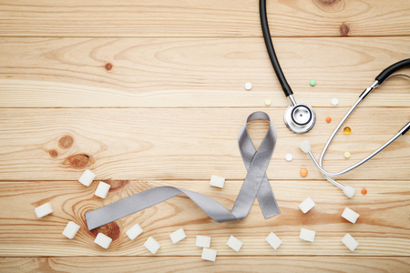 Grey ribbon with pills, sugar and stethoscope. Diabetes conceptの写真素材
