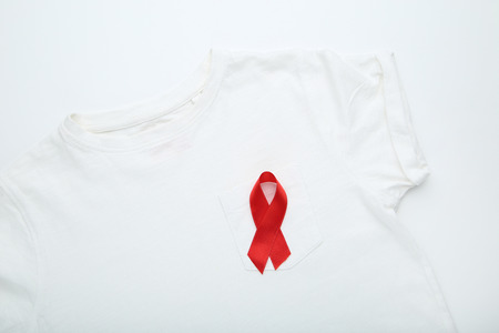 Red ribbon with white t-shirt. Medicine concept