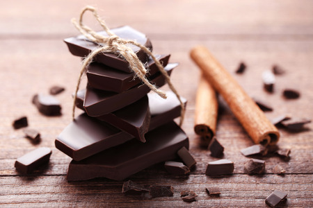Chocolate pieces with cinnamon on wooden tableの写真素材