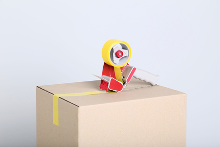 Cardboard box with dispenser on grey backgroundの写真素材