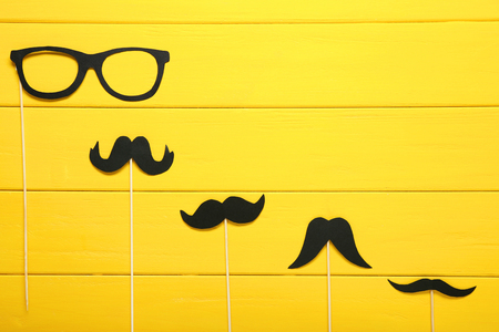 Paper booth props for party on yellow wooden tableの写真素材