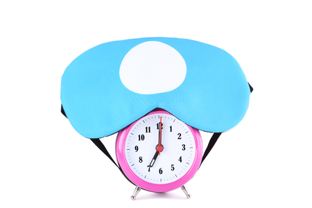 Sleeping mask with alarm clock isolated on white backgroundの写真素材