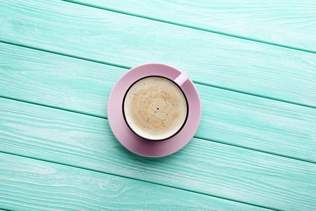 Cup of coffee on mint wooden tableの写真素材