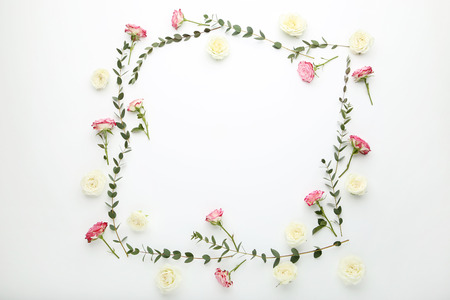 Rose flowers and stems with green leafs on white backgroundの写真素材