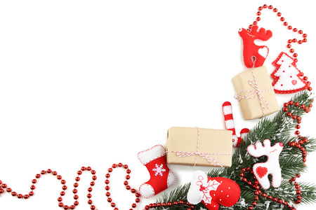 Christmas fir-tree branches with gift boxes on white backgroundの写真素材