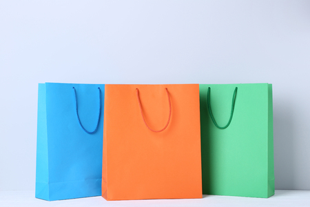 Colorful paper shopping bags on grey backgroundの写真素材