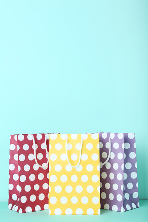 Colorful paper shopping bags on mint backgroundの写真素材