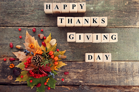 Autumn leafs and wooden cubes with inscription Happy Thanksgiving Dayの写真素材