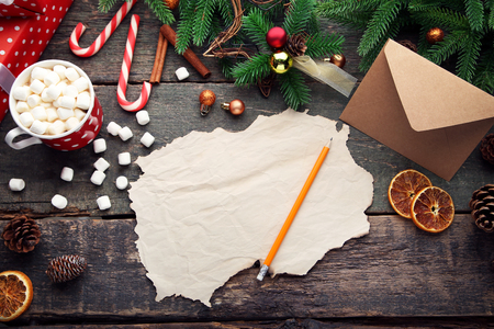 Blank sheet of paper with fir-tree branches and cup of coffeeの写真素材