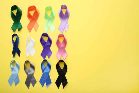 Colorful ribbons on yellow background. Medicine conceptの写真素材