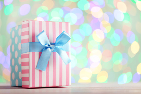 Gift box with ribbon on lights backgroundの写真素材