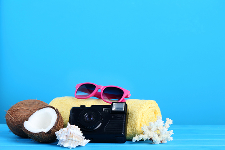 Coconuts with seashells and retro camera on blue backgroundの写真素材
