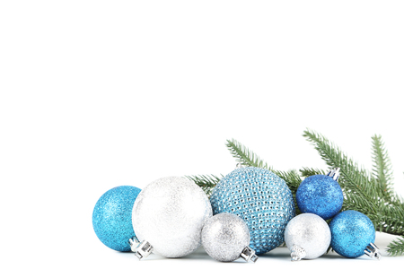 Colorful christmas baubles with fir tree branches on white backgroundの写真素材