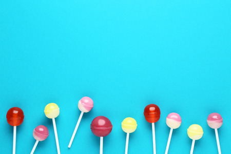 Sweet lollipops on blue backgroundの写真素材